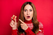 © deagreez - Portrait of attractive trendy cheerful amazed girl holding in hand demonstrating tiny giftbox congrats isolated over bright red color background