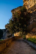 Stone Path Of The Monastery Of Sant Miquel Del Fai With Cliff At Sunset, Ametlla Del Valles Catalonia Spain