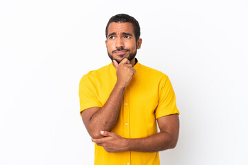 Sticker - Young Ecuadorian man isolated on white background thinking an idea while looking up