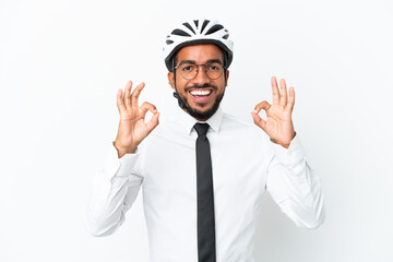 Poster - Young business latin man holding a bike helmet isolated on white background showing an ok sign with fingers