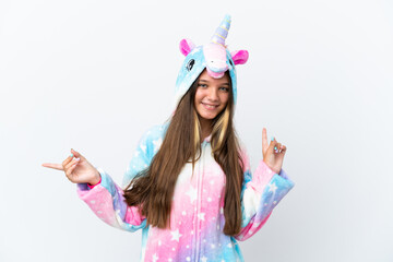 Poster - Little caucasian girl wearing unicorn pajama isolated on white background pointing finger to the laterals and happy