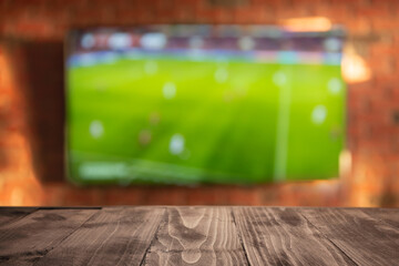 Empty wooden table on the background of the TV in the living room