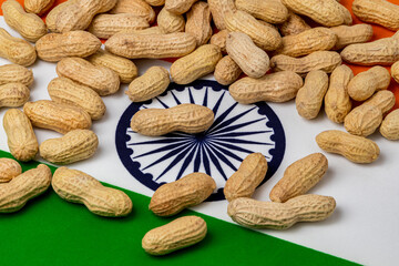 Wall Mural - Peanuts in shell on flag of India. Peanut farming, trade, tariffs and market price concept.