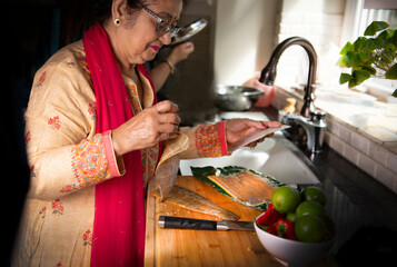 Woman skinning a fish 