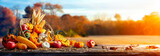 Fototapeta Dmuchawce - Basket Of Pumpkins, Apples And Corn On Harvest Table With Field Trees And Sky Background - Thanksgiving
