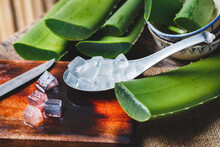 Spoon With Ice Cubes And Fresh Green Aloe Vera Leaves