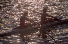 Two Men Rowing In Double Scull On Water