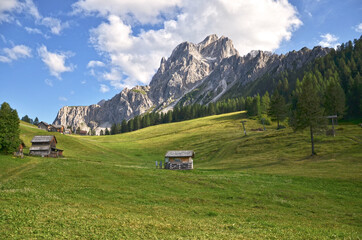 Sticker - Mountain view: Rugged rocks green meadows.