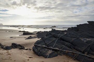 Poster - Sunset on the Atlantic Ocean. Black rocks at the west coast Algarve, Portugal. Dream coast.