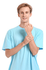 Wall Mural - Sporty young man counting pulse on white background