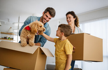 Wall Mural - Family unpacking cardboard boxes at new home