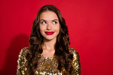 Sticker - Photo of dreamy young thoughtful woman look empty space smile christmas party isolated on red color background