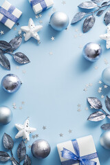 Merry Christmas vertical banner design. Silver and white Christmas decorations on blue background. Modern Xmas poster mockup.