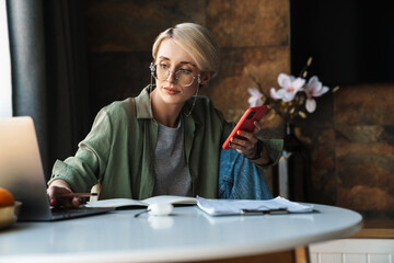 Sticker - Middle aged blonde woman with short hair studying