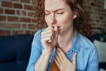 Caucasian Red Head Woman Coughing And Having Lungs Infection