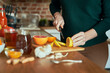 © gpointstudio - Unrecognizable woman cutting lemon for winter tea