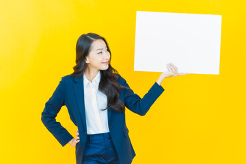 Wall Mural - Portrait beautiful young asian woman with empty white billboard