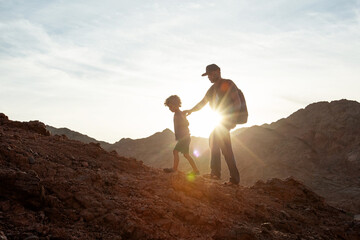 Wall Mural - Dad with son in the mountains in the desert