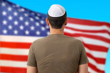 Back View Of Jewish Citizen Wearing Yarmulke In Front Of American Flag For Multi-ethnicity Nature Of USA