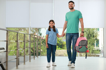 Canvas Print - Father with his little daughter in school hall