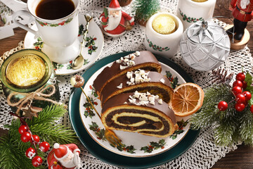 Wall Mural - Christmas poppy seed roll cake on festive table