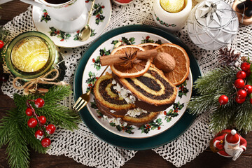 Wall Mural - Christmas poppy seed roll cake on festive table