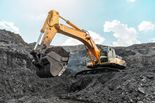 Large Quarry Dump Truck. Big Yellow Mining Truck At Work Site. Loading Coal Into Body Truck. Production Useful Minerals. Mining Truck Mining Machinery To Transport Coal From Open-pit Production