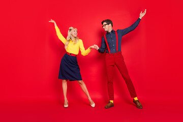 Canvas Print - Full length body size view of attractive cheerful couple dancing having fun isolated over bright red color background