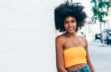 Wall Mural - Beautiful american girl posing against a white wall in New york