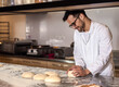 © Zoran Zeremski - Young male baker preparing dough for bread in modern manufacturing.