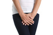 Young sick woman holds hands pressing to perineum to lower abdomen