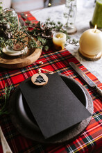 Christmas Table Setting With Empty Menu On Checkered Red Tablecloth