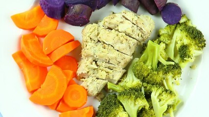 Wall Mural - Baked chicken breast  with broccoli  carrot and purple sweet potato in plate , in studio Chiangmai Thailand.