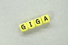 A Yellow Cube With The Word Giga. Technology Concept