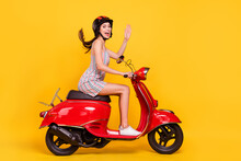 Full Length Body Size Side Photo Woman Riding Bike Wearing Dress Helmet Waving Hand Greeting Isolated Bright Yellow Color Background