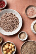 © The Picture Pantry - An overhead view of a variety of pantry staples, including beans, quinoa, and spices, shot on a terra cotta background