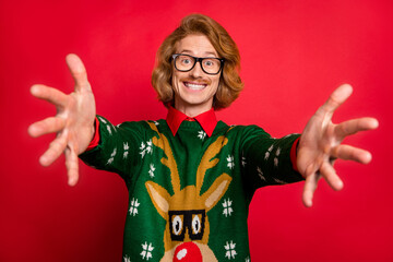 Sticker - Photo of cute impressed young guy dressed print pullover glasses open arms wanting hug you smiling isolated red color background