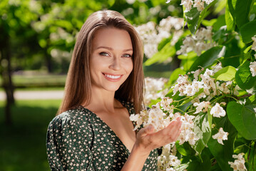 Sticker - Photo of nice brown haired happy cheerful woman smile spring flowers trees bloom outdoors outside park street