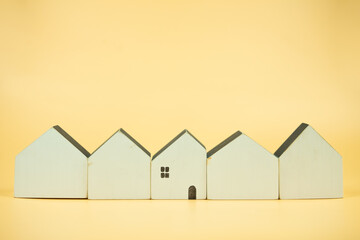 Wall Mural - A row of white wooden houses with a single the best wooden house