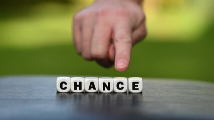 Wall Mural - Hand is turning a dice and changes the word chance to change.