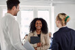 © Johnér - Coworkers talking in office