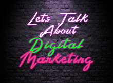 Lets Talk About Digital Marketing Neon Sign. Glowing Bright Lettering On Dark Brick Wall Background.  Neon Effect Text. Digital Marketing Discussion Concept 