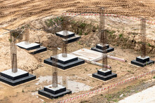 Monolithic reinforced concrete foundations for the construction of a residential building. Grillage at the construction site. Construction pit with foundations.