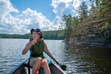 Woman canoeing at lake with dog