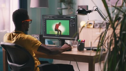 African American man editing video with chromakey background