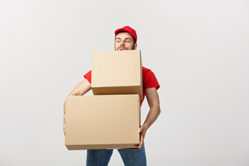 Wall Mural - Delivery man doing surprise gesture holding cardboard boxes.