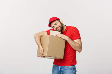 Wall Mural - Portrait delivery man in cap with red t-shirt working as courier or dealer holding two empty cardboard boxes. Receiving package. Copy space for advertisement