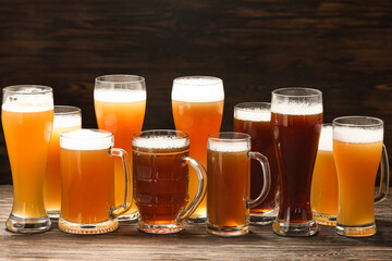 Mugs and glasses of cold beer on table. Oktoberfest celebration