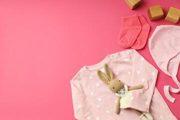 Wall Mural - Concept of female baby clothes on pink background