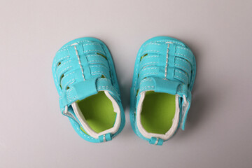 Wall Mural - Mint baby sandals on light gray background